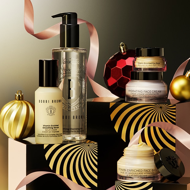 Model applying Skin Long-Wear Weightless Foundation to skin with a foundation brush